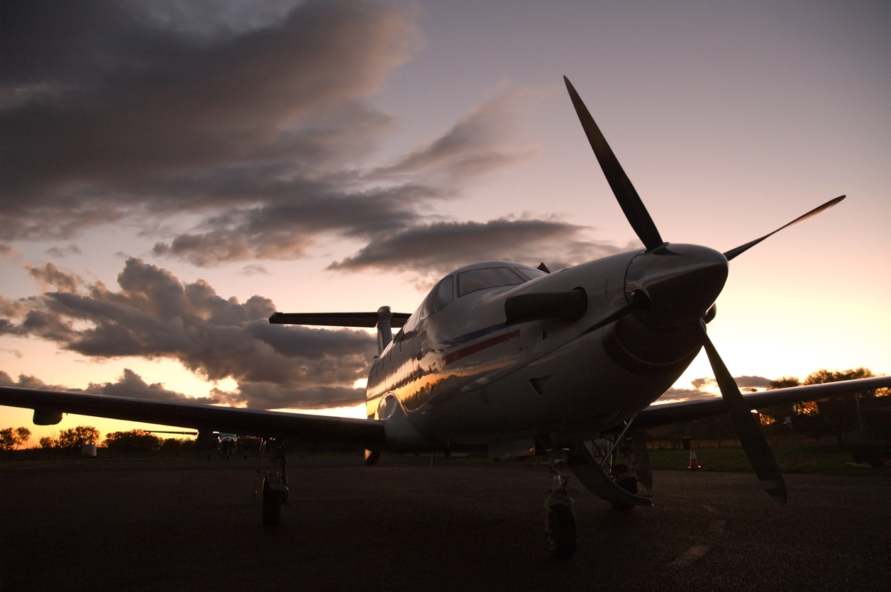 A single engine turbine aircraft at sunset